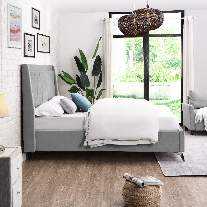 Modern bedroom with grey bed, white bedding, and a plant.