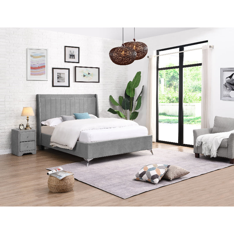 Modern bedroom with grey upholstered bed, nightstands, and decor.