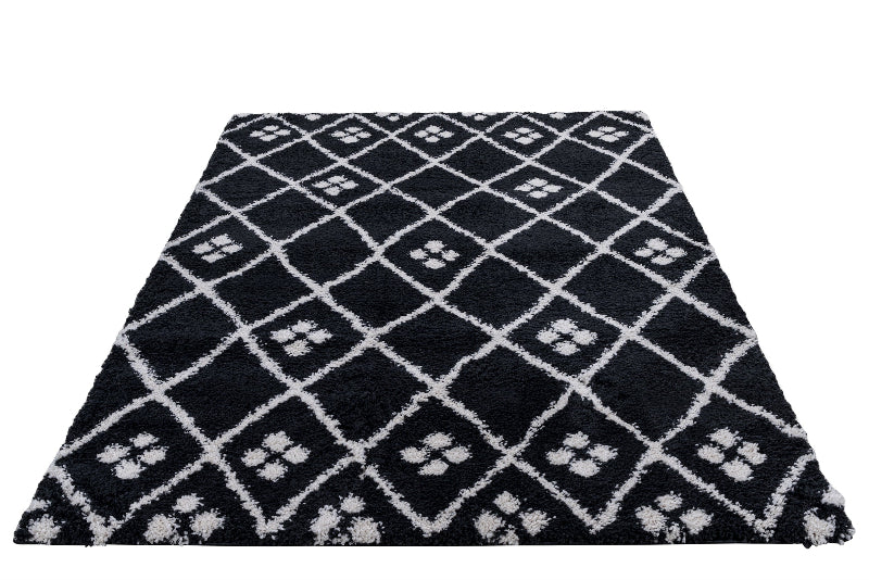 Black and white patterned rug with paw prints on a white background