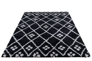 Black and white patterned rug with paw prints on a white background