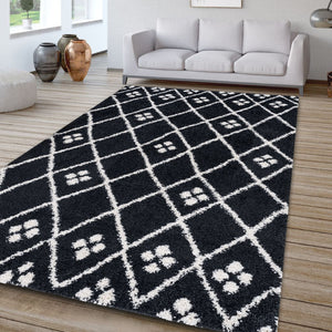 Black and white patterned rug on a wooden floor with a gray sofa in the background.