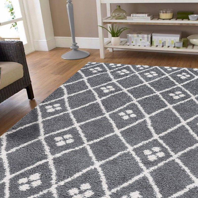 Grey checkered rug on a wooden floor with a shelf in the background