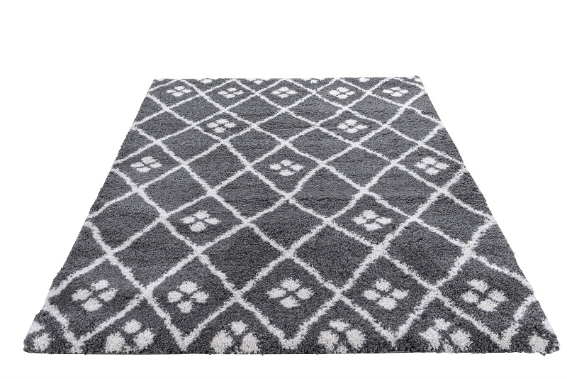 Grey and white patterned rug on a white background