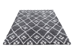 Grey and white patterned rug on a white background