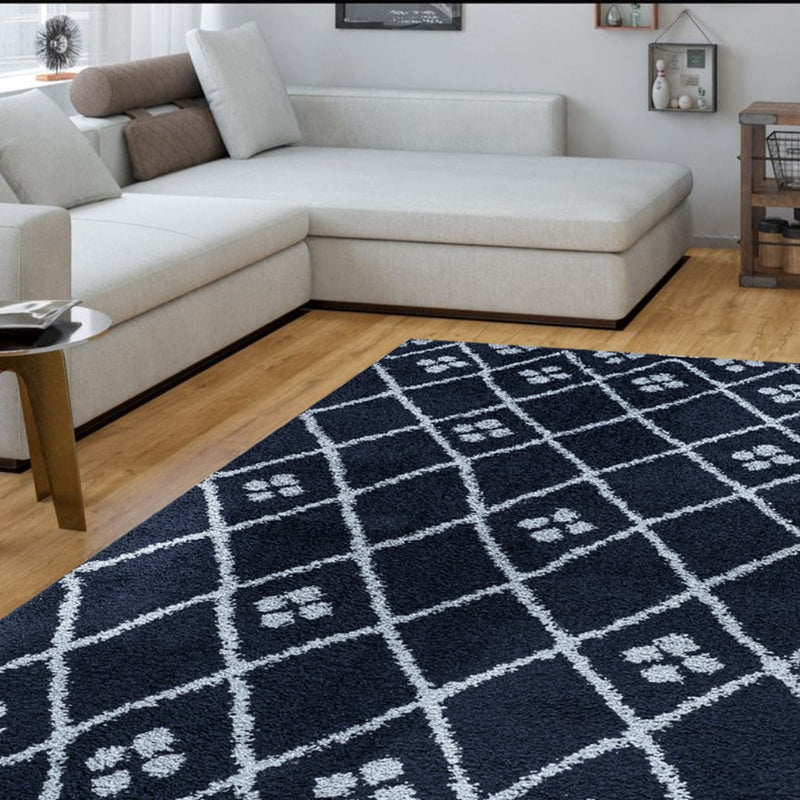 Navy blue and white patterned rug in a living room with a beige sectional sofa.