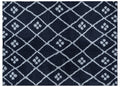 Navy blue rug with white geometric pattern