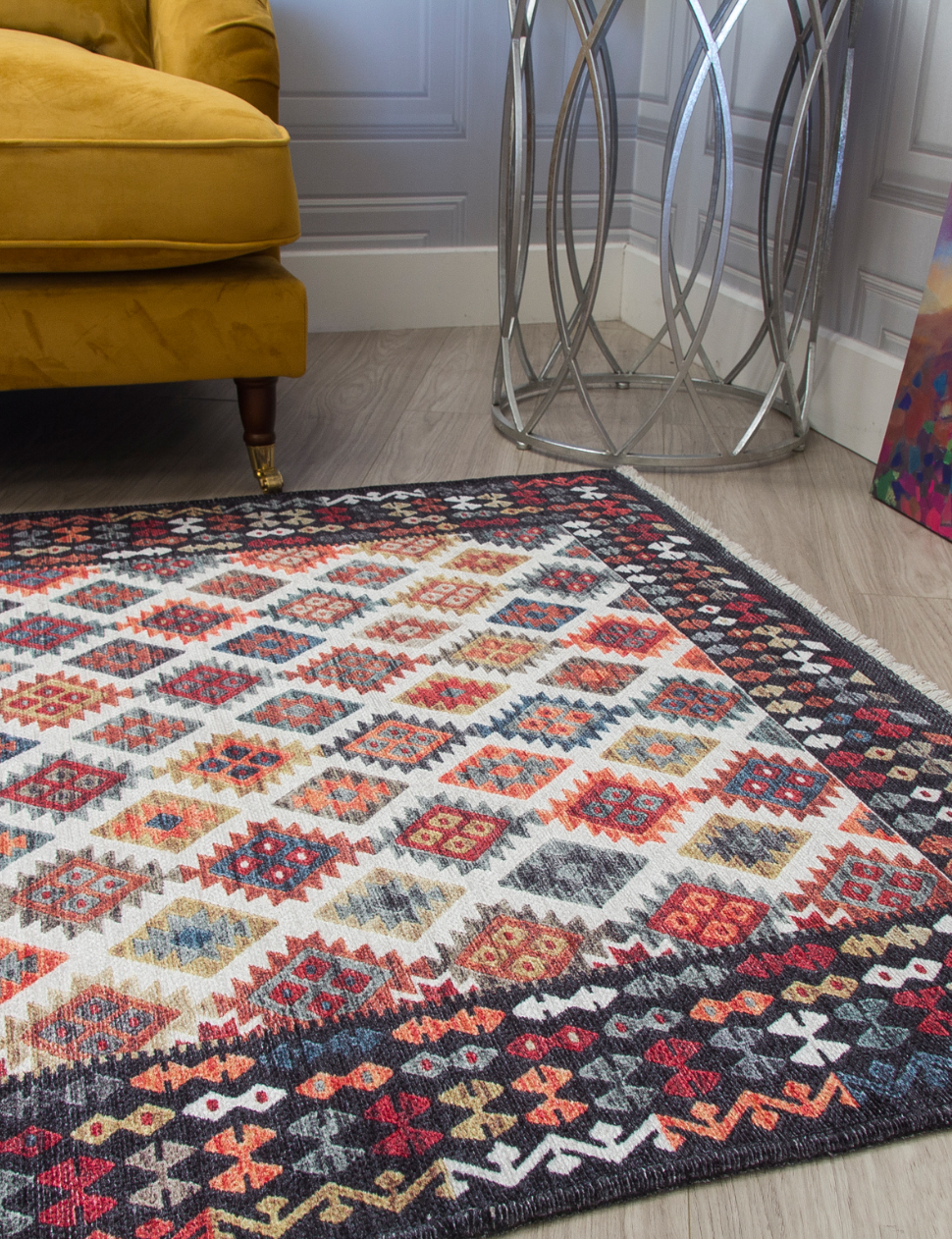 Patterned rug on a wooden floor with a yellow armchair and decorative side table in the background.