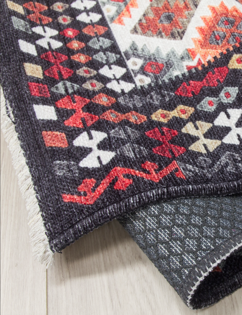 Two patterned rugs with geometric designs on a light wooden floor.