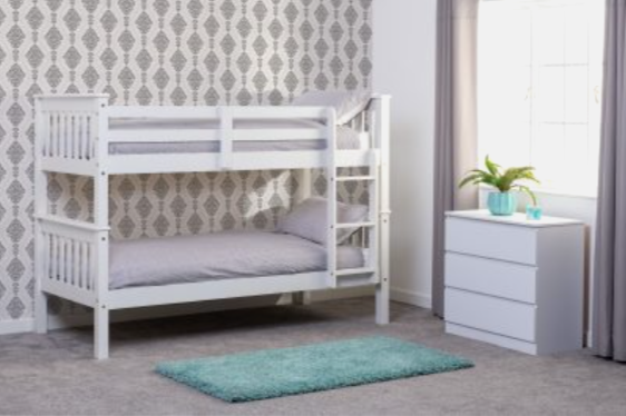 White bunk bed in a room with patterned wallpaper and a nightstand.