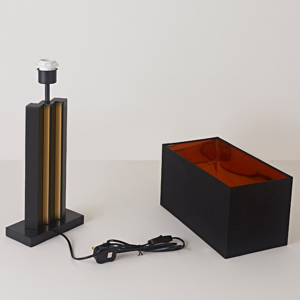 Two lamps on a white surface with a plain background