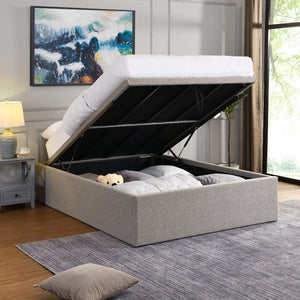 Gray upholstered bed with open storage compartment in a bedroom setting.
