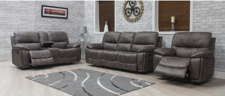 Brown leather reclining sofa set in a living room with a gray rug and decorative items.