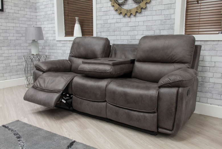 Gray recliner sofa in a room with a brick wall and window blinds.