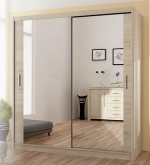 Sliding wardrobe with mirror doors in a room with furniture and decor.