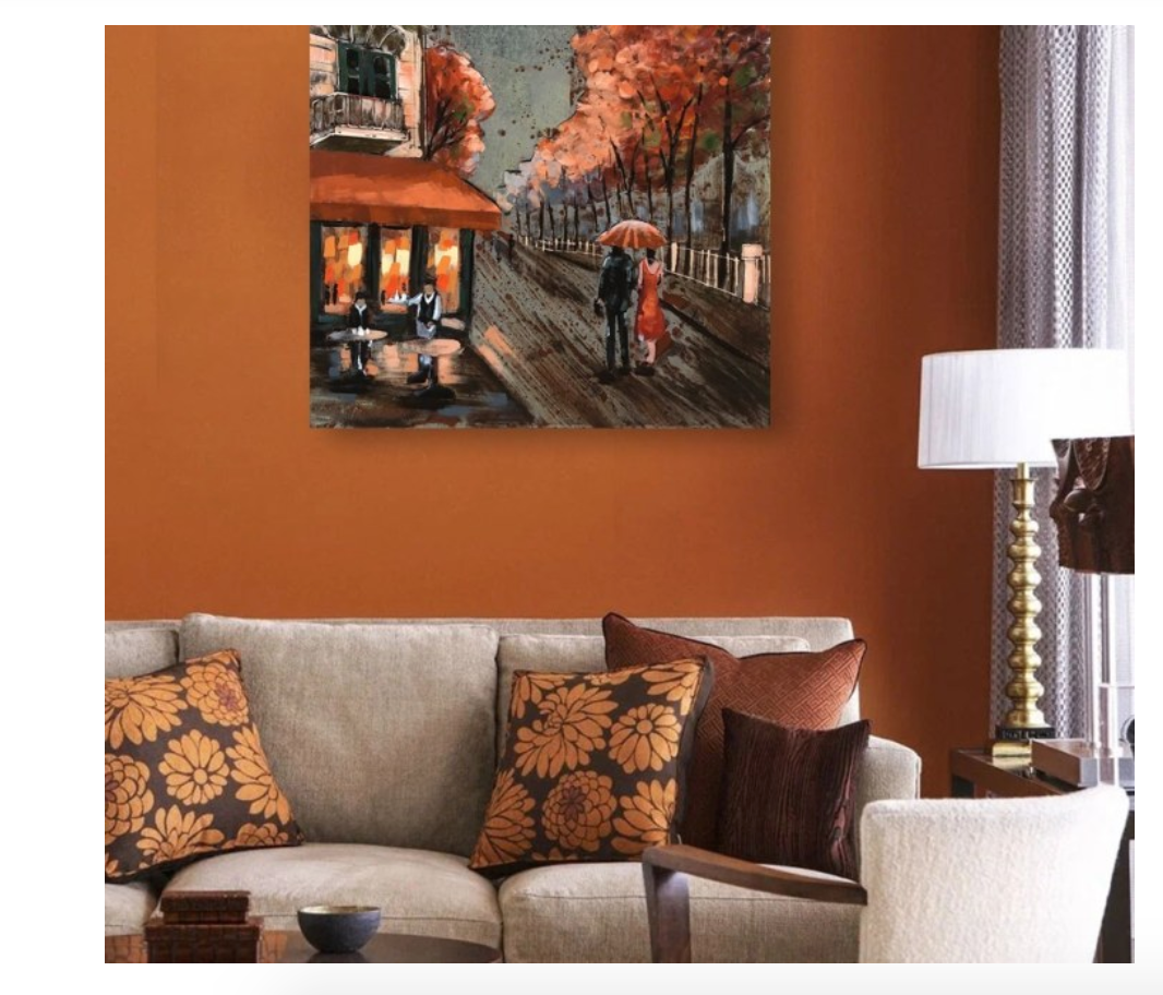 Living room with a painting of a couple under an umbrella on an orange wall.