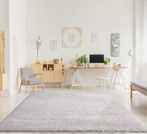Modern home office with a desk, chairs, and decor elements.