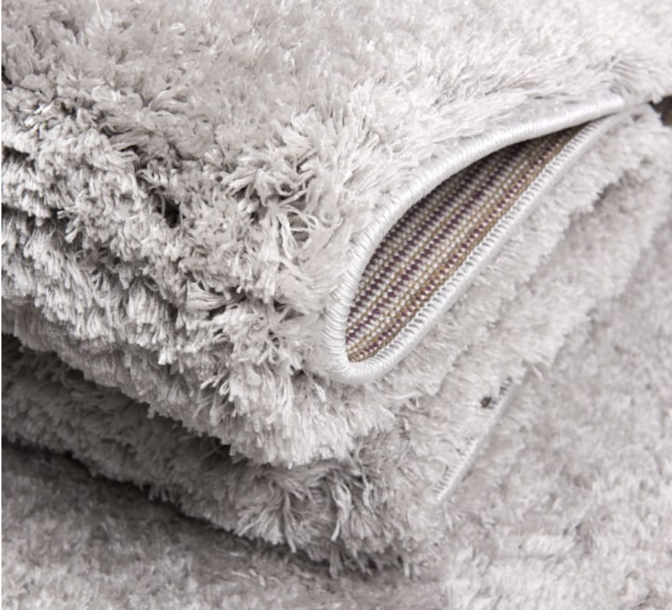 Close-up of a textured gray rug with a zipper