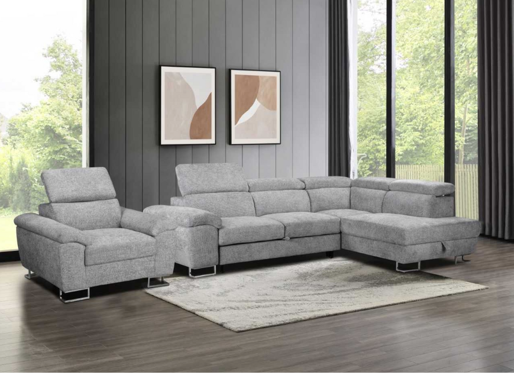 Gray sectional sofa in a living room with large windows and abstract art on the wall.