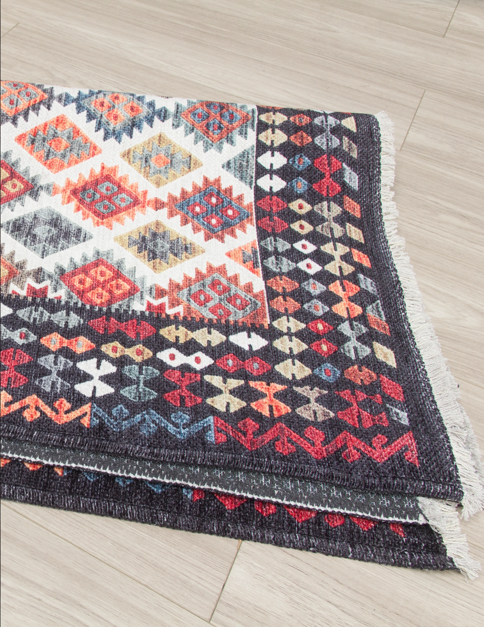 Patterned rug with geometric design on a wooden floor