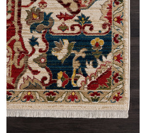 Close-up of an ornate rug with intricate patterns on a wooden floor.