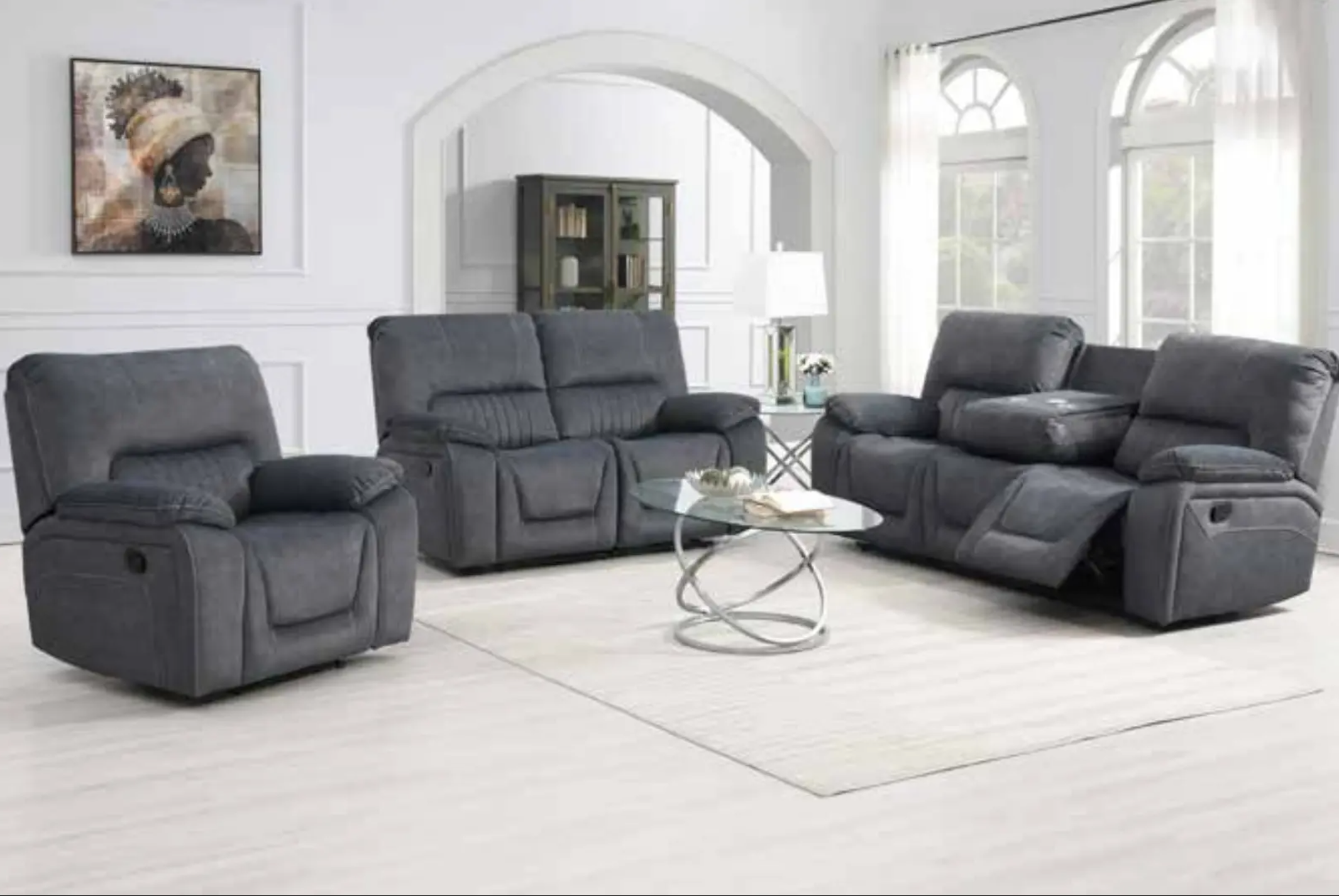 Gray reclining sofa set in a living room with a mirror and decor.