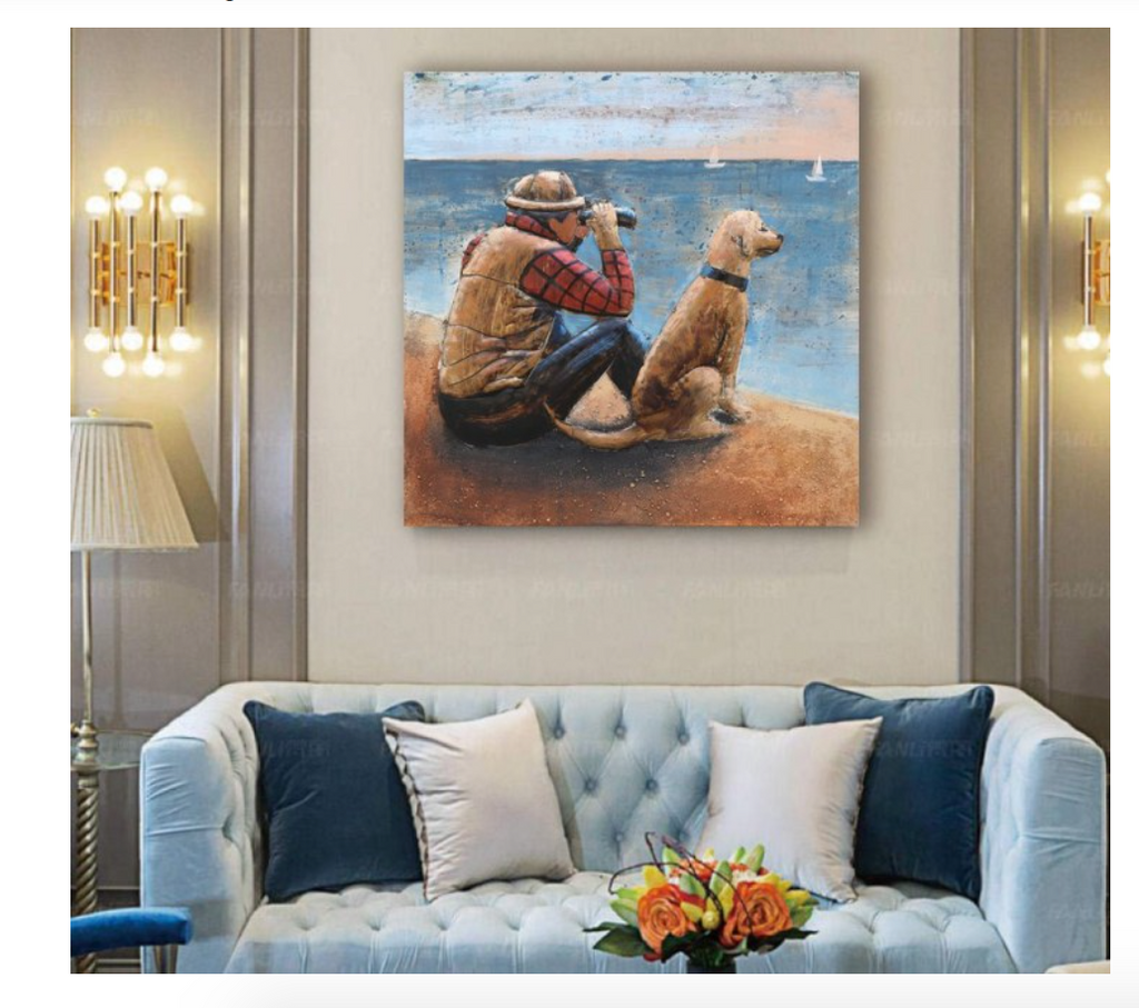 Painting of a man and dog on a wall above a sofa with decorative pillows and flowers.
