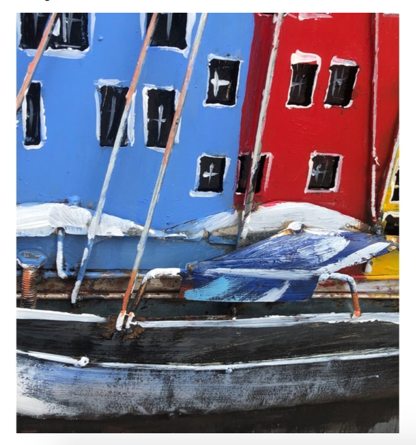 Colorful boats docked in front of buildings with black windows.