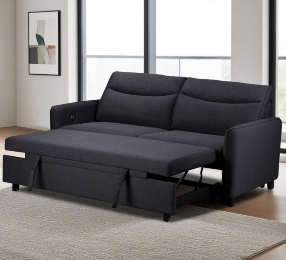 Black sofa bed in a room with large windows and a rug.