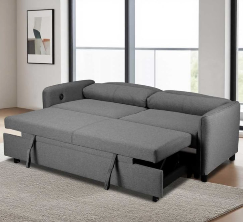 Gray sectional sofa with pull-out bed in a room with large windows.