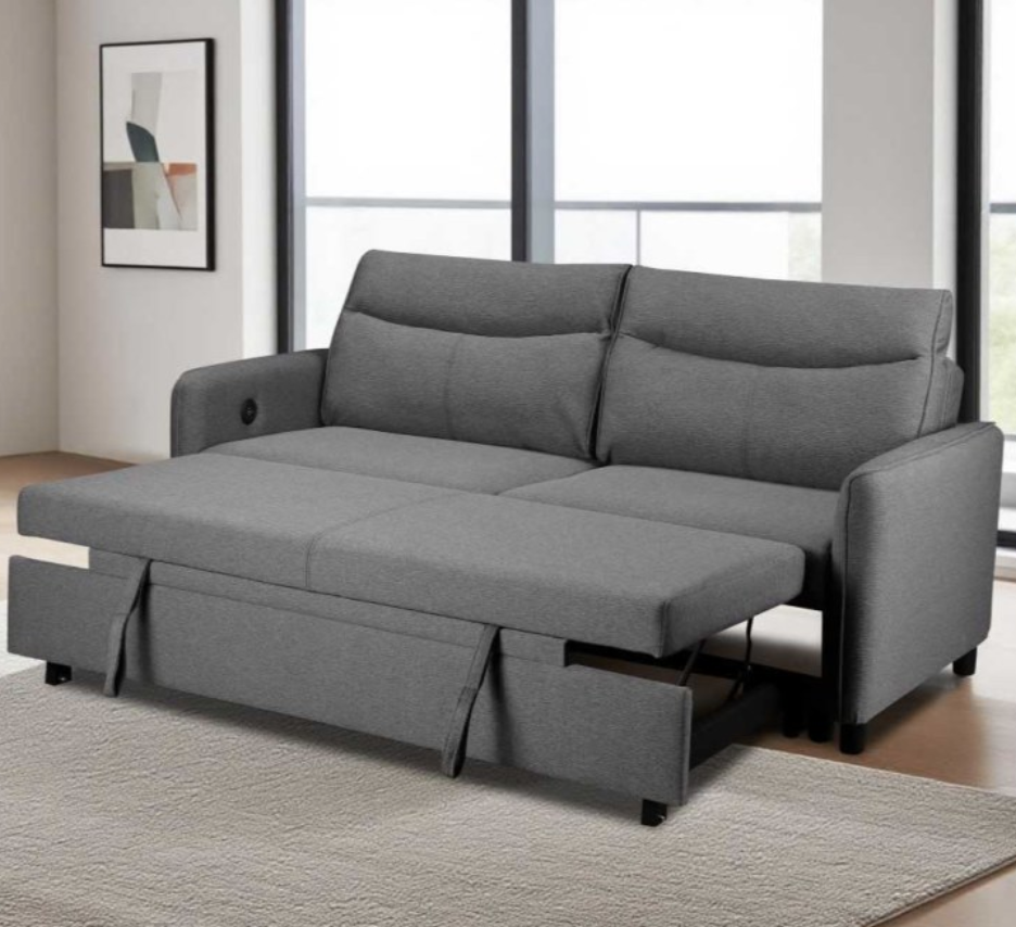 Gray sofa bed in a room with large windows and a rug.