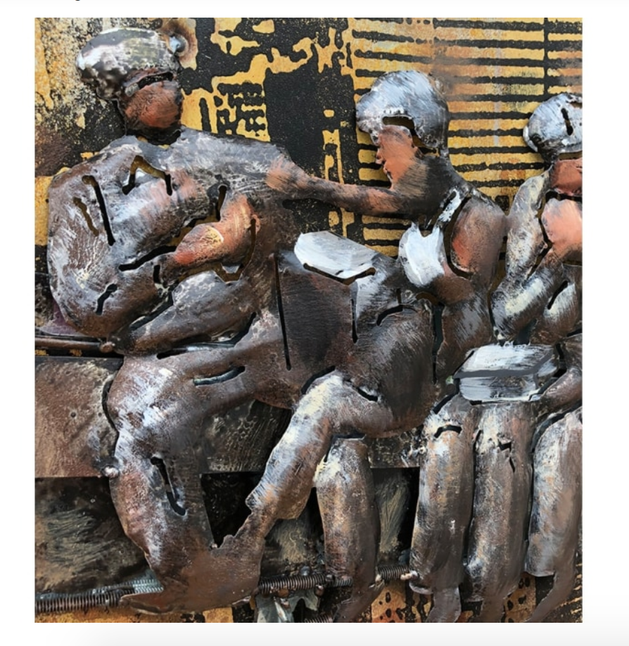Metallic sculpture of figures in a dynamic pose against a textured background