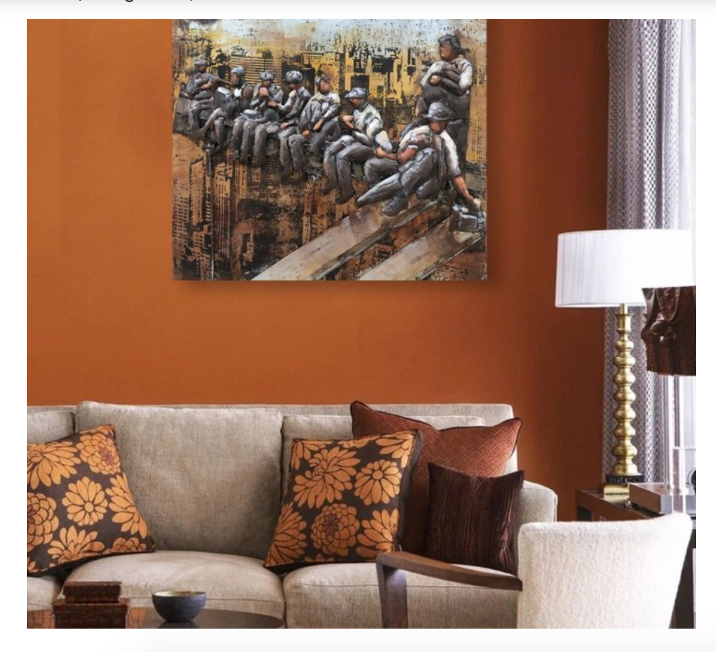 Living room with a painting of people on a wall, a couch with patterned pillows, and a lamp.