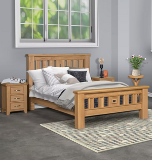 Wooden bed with bedding in a room with a window and side tables.