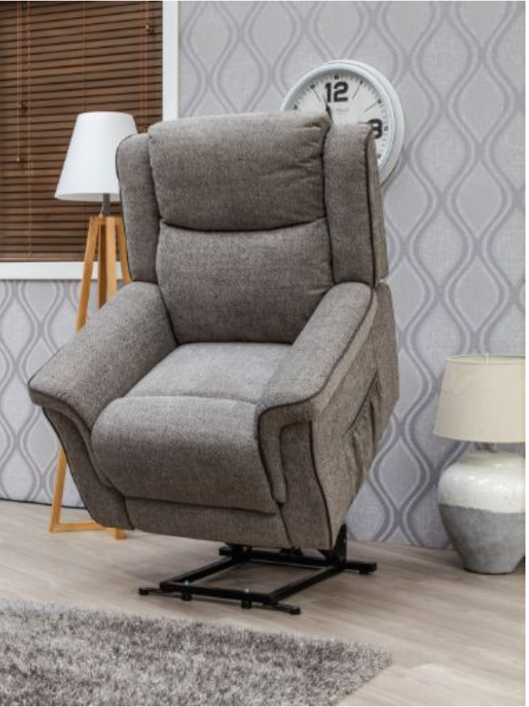 Gray recliner chair in a room with patterned wallpaper and decor items.
