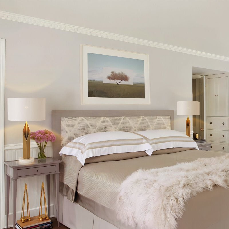 Neatly made bed in a bedroom with decorative elements.