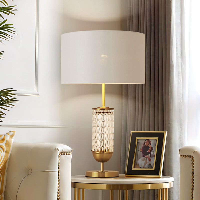 Decorative lamp on a side table with a framed picture in a living room setting.