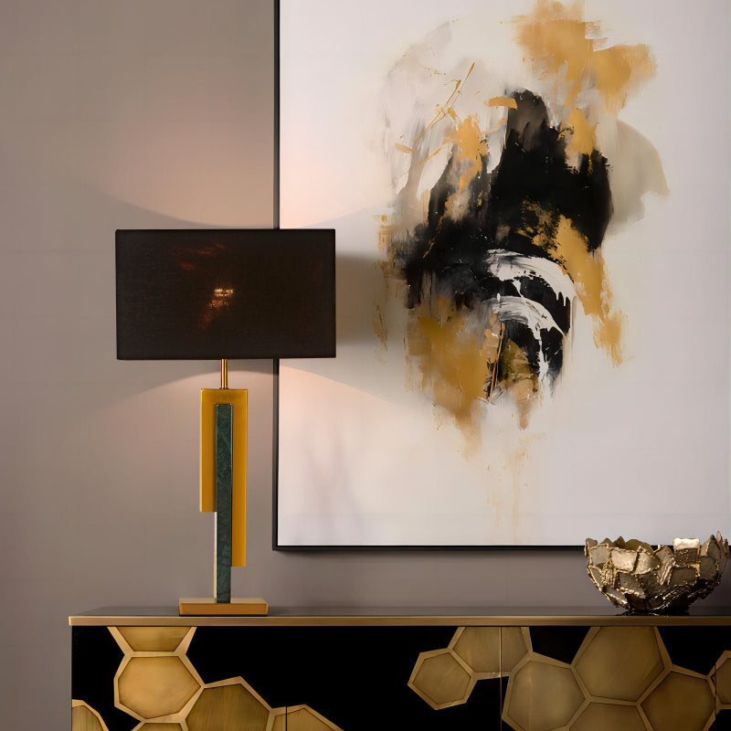 Modern interior with abstract art, lamp, and decorative bowl on a console table.