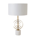 Table lamp with white shade and gold decorative base on a white background