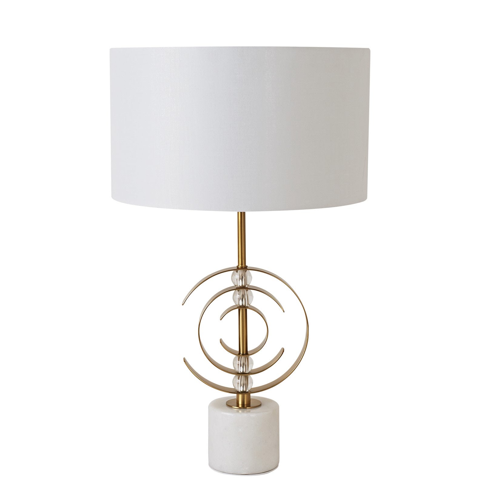 Table lamp with white shade and gold decorative base on a white background