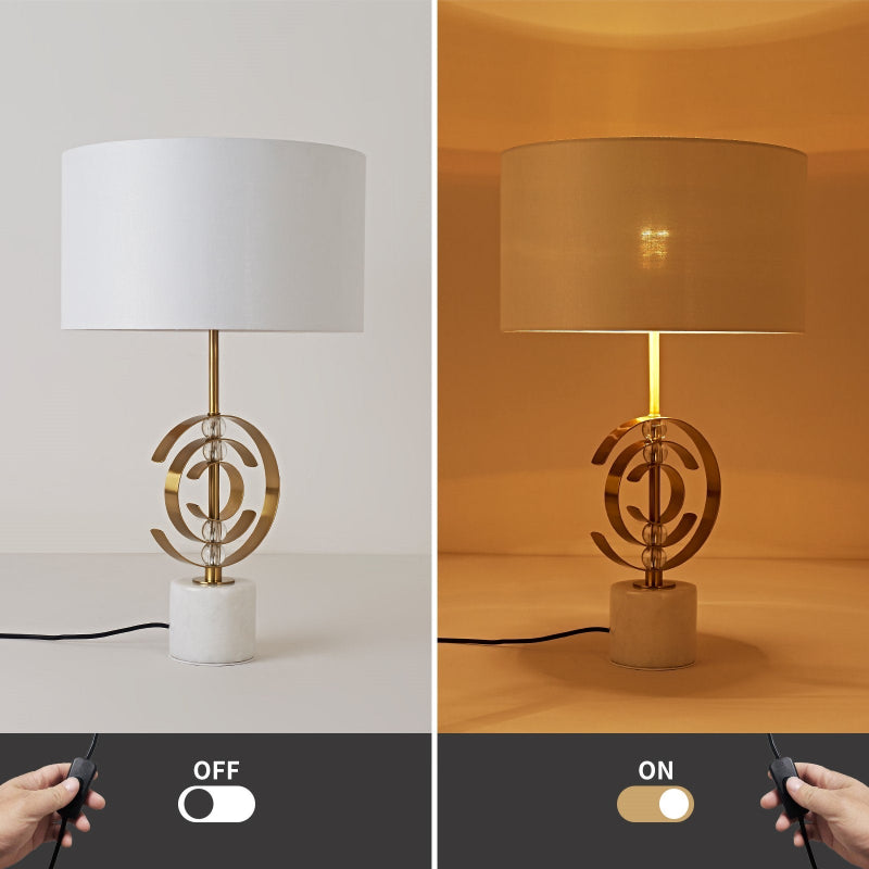 Table lamp with decorative base and remote control on a neutral background