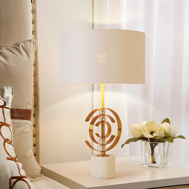 Decorative lamp with a unique design on a table next to a chair and a small plant.