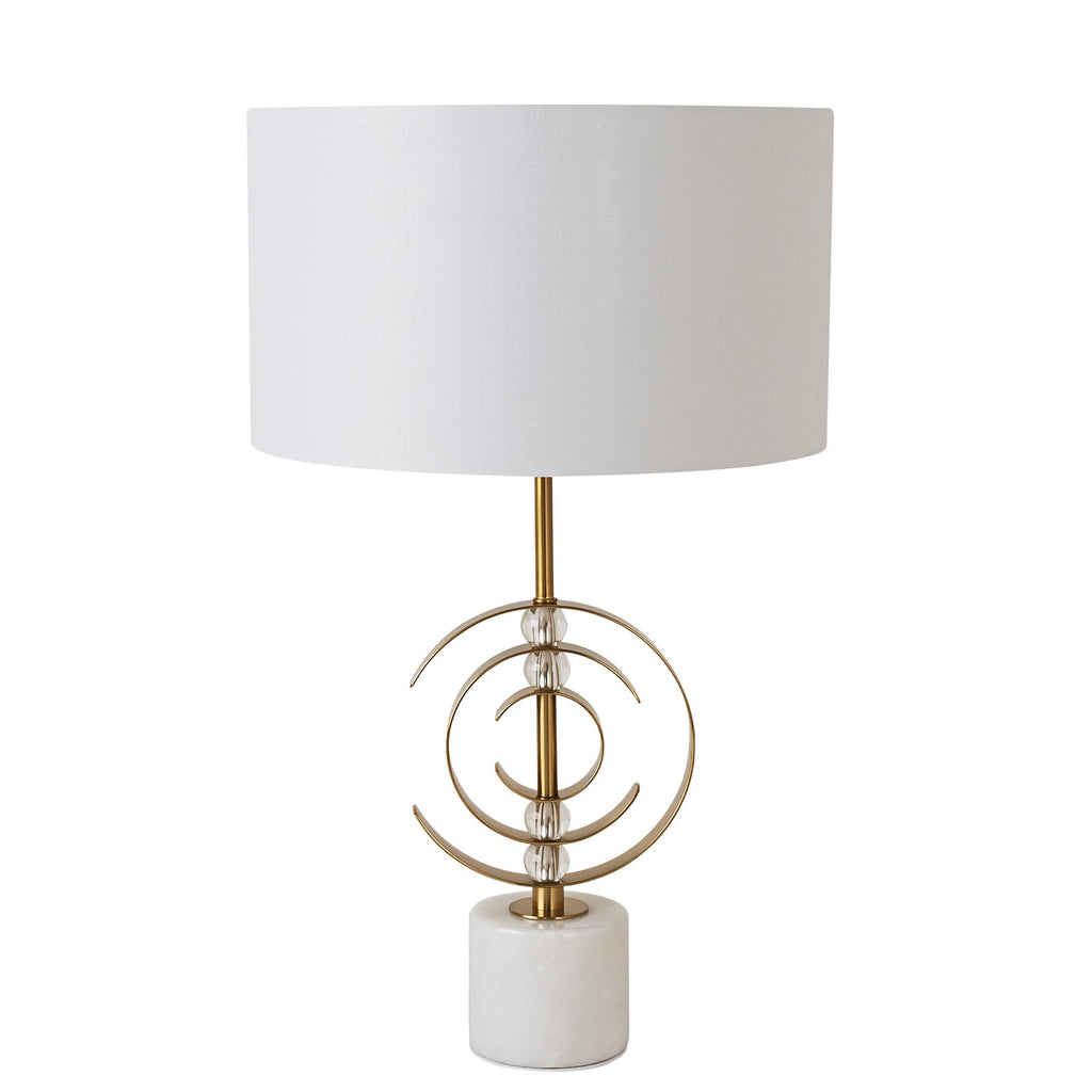 Table lamp with white shade and gold decorative base on a white background