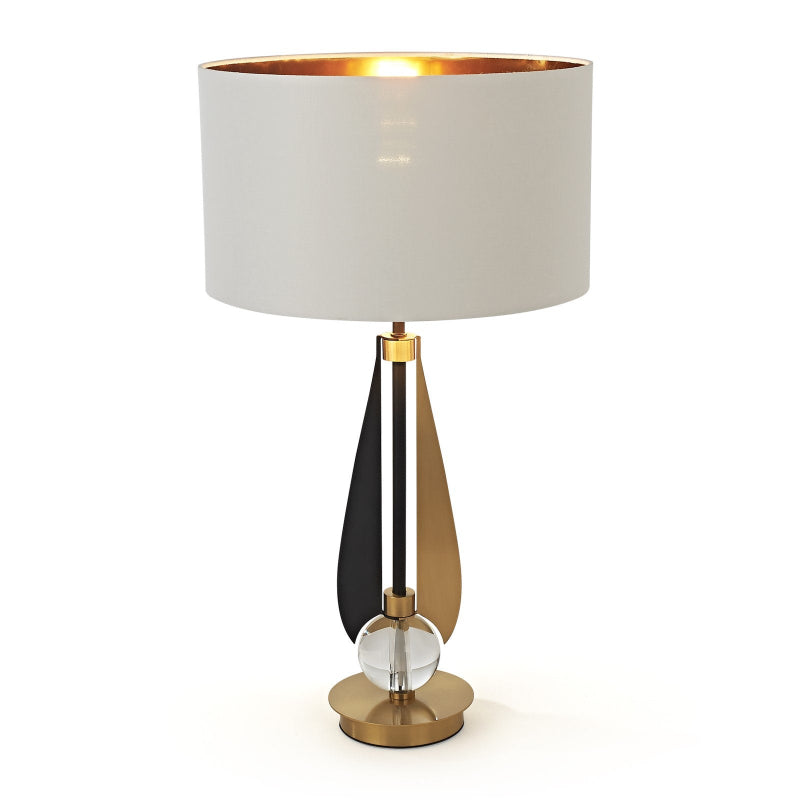 Decorative table lamp with a white shade and gold base on a white background