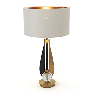 Decorative table lamp with a white shade and gold base on a white background
