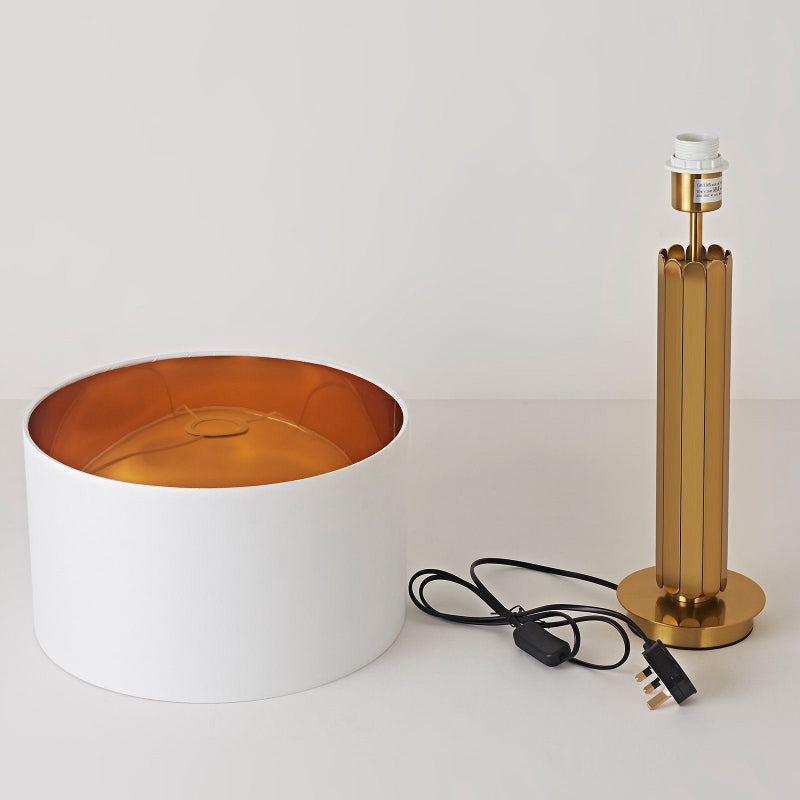 Gold and white lamp with base on a white background