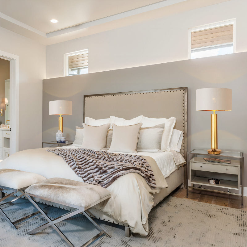 Modern bedroom with a large bed, nightstands, and lamps.