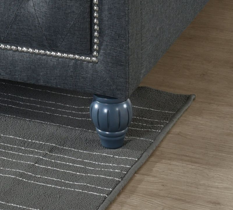 Grey rug with a decorative border on a wooden floor