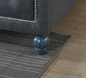 Grey rug with a decorative border on a wooden floor