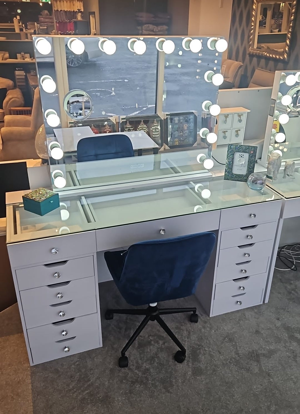 Makeup vanity with mirror and lights in a store setting
