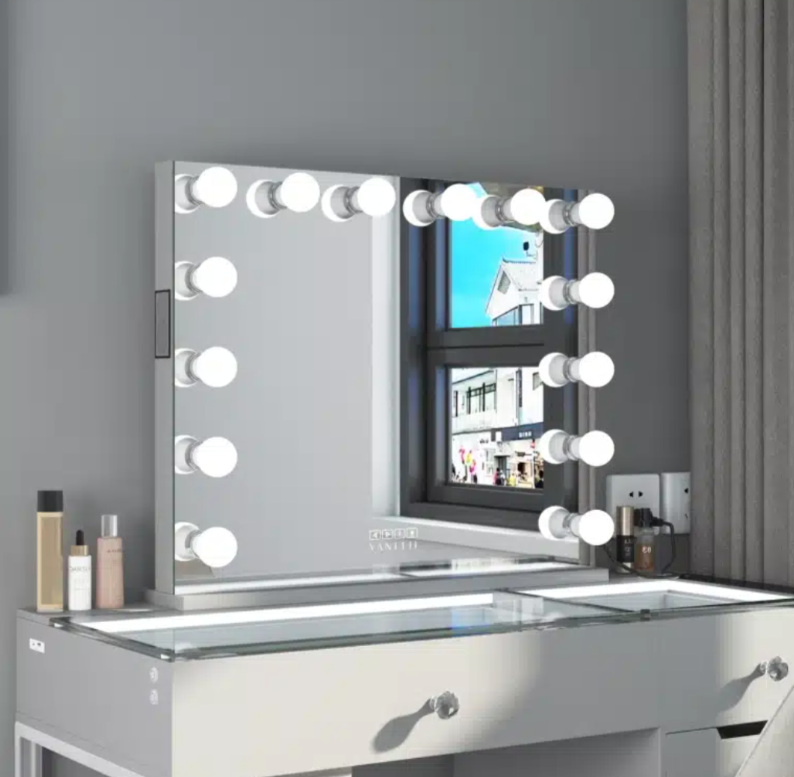 Makeup vanity with mirror and lights against a gray wall